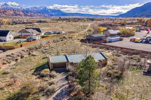 Aerial view of property and surrounding area with mountains