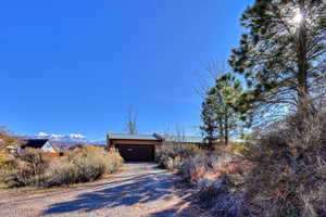 View of dirt / gravel driveway featuring a mountain view