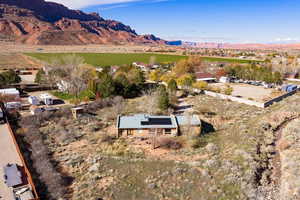 Aerial view of property's location with a mountain backdrop and rural landscape