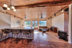 Dining space featuring track lighting, wood ceiling, and hardwood / wood-style floors