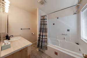 Bathroom featuring vanity and tiled shower / bath combo