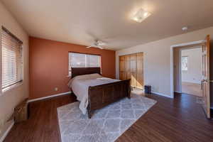 Bedroom with a closet, dark wood-type flooring, anhttps://assets.utahrealestate.com/photos/280x210/2124608_da46e38eeda878c9b149133c5e650713_6924e1180ceb2.jpgd a ceiling fan