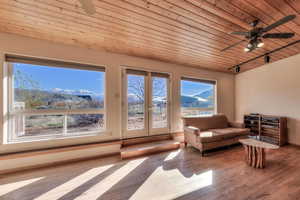 Living area featuring wooden ceiling, a ceiling fan, french doors, and hardwood / wood-style flooring