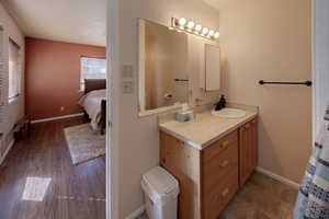 Ensuite bathroom featuring baseboards and vanity