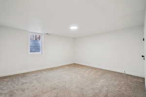 1597 - Empty room with light carpet and baseboards