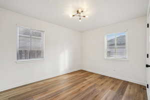 1597 - Unfurnished room featuring light wood finished floors and baseboards