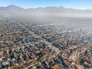 Aerial overview of property's location featuring a mountainous background and nearby suburban area
