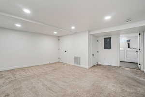 1597 - Finished below grade area with washing machine and clothes dryer, electric panel, carpet, and recessed lighting