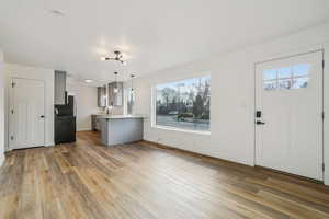 1597 - Kitchen featuring gray cabinetry, decorative light fixtures, light countertops, a peninsula, and open floor plan