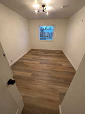 2697 - Unfurnished room featuring wood finished floors and baseboards