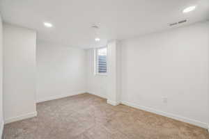 1597 - Empty room featuring light carpet and recessed lighting