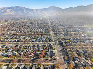 Aerial overview of property's location featuring a mountainous background and nearby suburban area