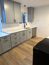 2697 - Kitchen with gray cabinetry, black electric range oven, light stone countertops, and light wood finished floors