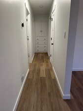 2697 - Hallway with baseboards and dark wood-style flooring