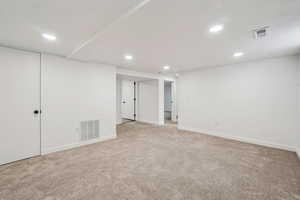 1597 - Finished below grade area with light carpet and recessed lighting