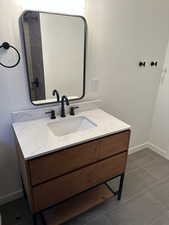 2697 - Bathroom with vanity and dark tile patterned floors