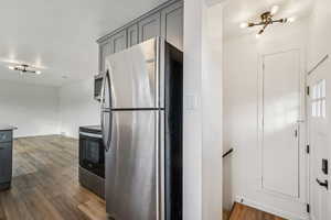 1597 - Kitchen with appliances with stainless steel finishes, gray cabinetry, and dark wood-style floors