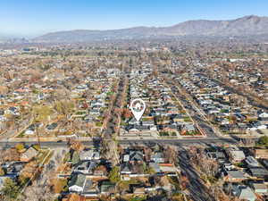 Aerial overview of property's location with a mountain backdrop and nearby suburban area