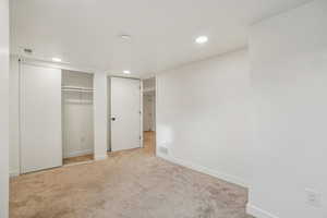 1597 - Unfurnished bedroom with carpet, a closet, and recessed lighting