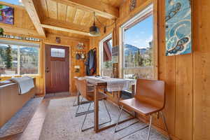 Dining area featuring a mountain view and beamed ceiling