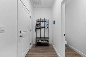 Workout room with dark wood-style flooring