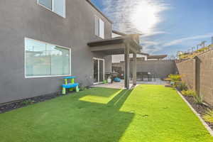 Fenced backyard with a patio area