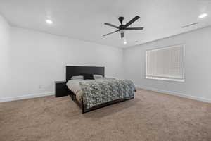Bedroom with a ceiling fan, light carpet, and recessed lighting