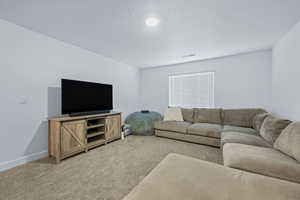 Living area with carpet floors and baseboards