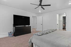 Bedroom featuring a ceiling fan, light colored carpet, recessed lighting, and a walk in closet