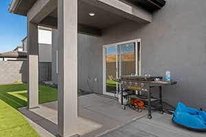 View of patio featuring a grill
