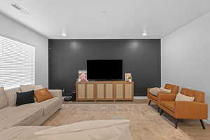 Living room featuring wood finished floors and recessed lighting