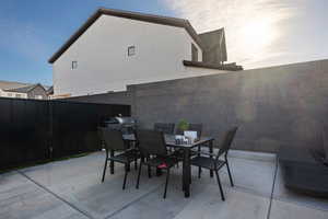 Fenced backyard featuring outdoor dining space and a patio area
