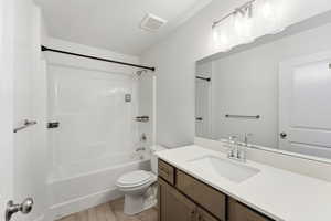 Full bath featuring bathing tub / shower combination, vanity, and light wood-type flooring