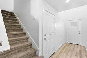 Stairs featuring baseboards and wood finished floors