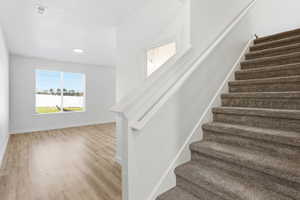 Stairs featuring baseboards and wood finished floors