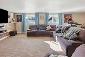 Living area featuring carpet flooring and baseboards
