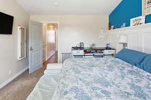 Carpeted bedroom with baseboards
