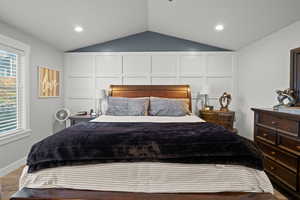Bedroom with vaulted ceiling, recessed lighting, and wood finished floors