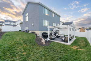 Back of house featuring an outdoor living space, a pergola, a fenced backyard, and a patio area