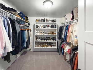 Walk in closet with light carpet