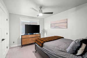 Bedroom featuring light carpet and ceiling fan