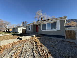 View of front facade with brick siding and roof mounted solar panels