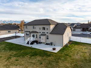 Back of property with a patio, a fenced backyard, stucco siding, a shingled roof.