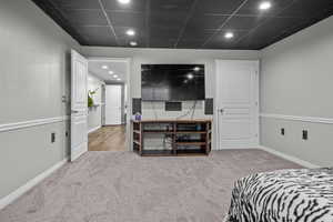 Bedroom featuring recessed lighting, carpet floors, and a paneled ceiling