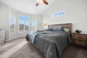 Bedroom with multiple windows, carpet, lofted ceiling, and a ceiling fan