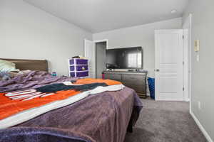 Carpeted bedroom with baseboards