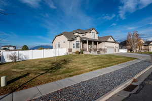 View of front with a porch, stucco siding, and driveway