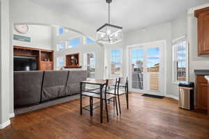 Dining space with a chandelier and dark wood finished floors