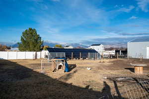 View of solar panels protected by fencing, fully fenced pasture space.