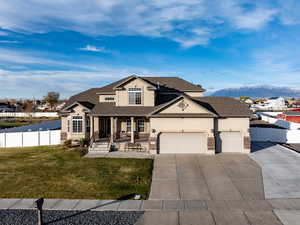 View of front of house featuring covered porch, stucco siding, concrete driveway, an attached garage, and roof with shingles